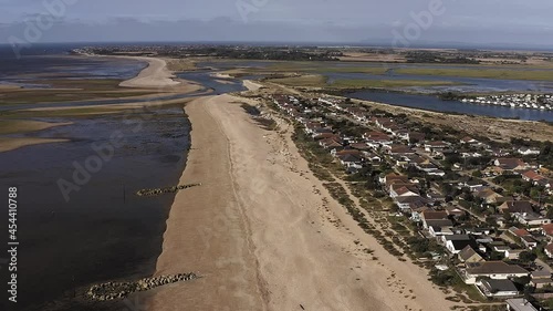 Aerial footage along Pagham beach in West Sussex, with the Pagham Harbour entrance and nature reserve in view. photo