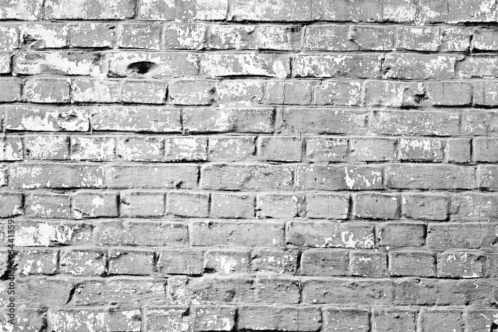 Fototapeta premium Texture of a brick wall with cracks and scratches which can be used as a background