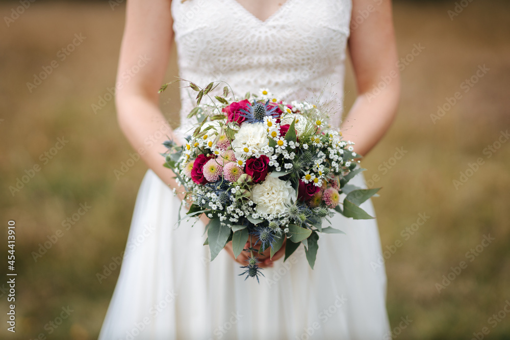 Bride holding beautiful wedding bouquet in her hands close-up Bride holding beautiful wedding bouquet in her hands close-up