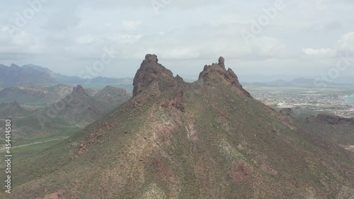 Aerial panoramic view of Cerro Tetakawi in San Carlos, Sonora, México. Drone rotating slowly with a cloudy sky and the city of Guaymas as background. photo