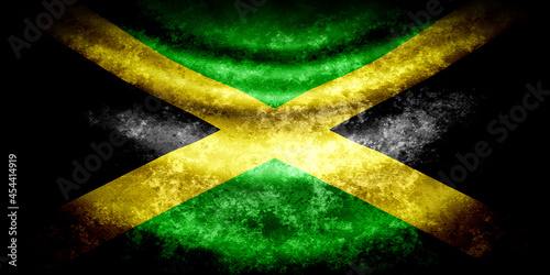 Jamaica wavy flag in grunge style with darkened edges. Aged texture