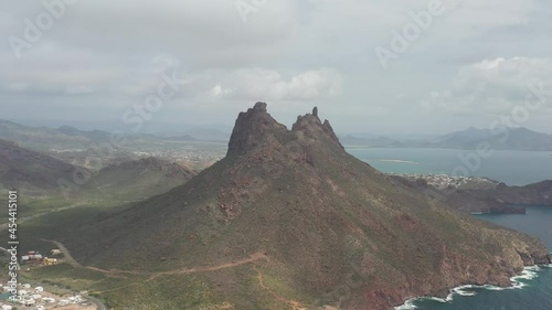 Aerial panoramic view of Cerro Tetakawi in San Carlos, Sonora, México. Drone flying backwards with a cloudy sky as background. photo