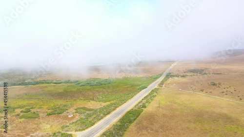 Cars travel in fog on Highway One along California's remote central coast near Big Sur or Monterey, California. photo