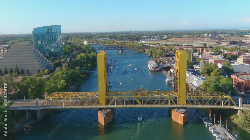 2021 - good aerial establishing shot of Sacramento River and Tower Bridge in Sacramento, California with boat traffic.