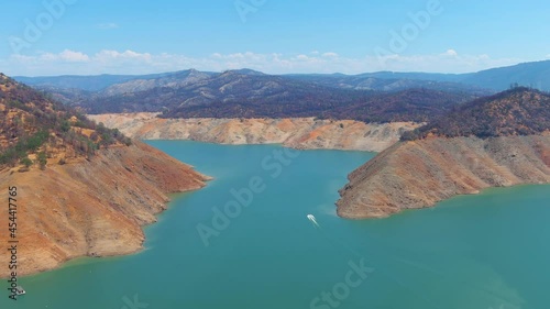 2021 - disturbing aerial over drought stricken California Lake Oroville with low water levels, receding shoreline and boats in the low water. photo