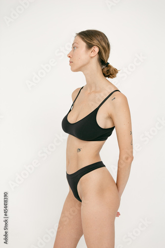 Beautiful girl without makeup with natural skin in lingerie on a white background