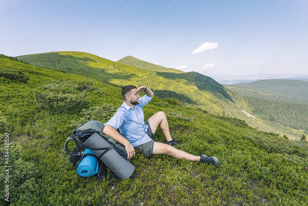 hiker in the mountains that looks like the beauty of the mountains. mountain hiking concept.