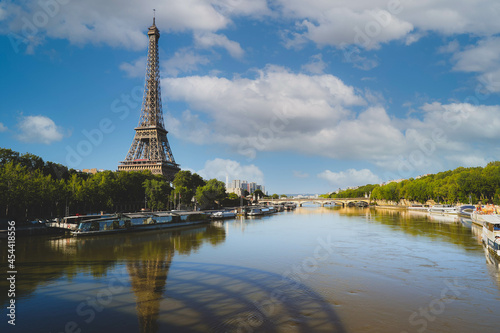 Eiffel Tower and Alexandre III Bridge with reflection on Seine river in Paris, France