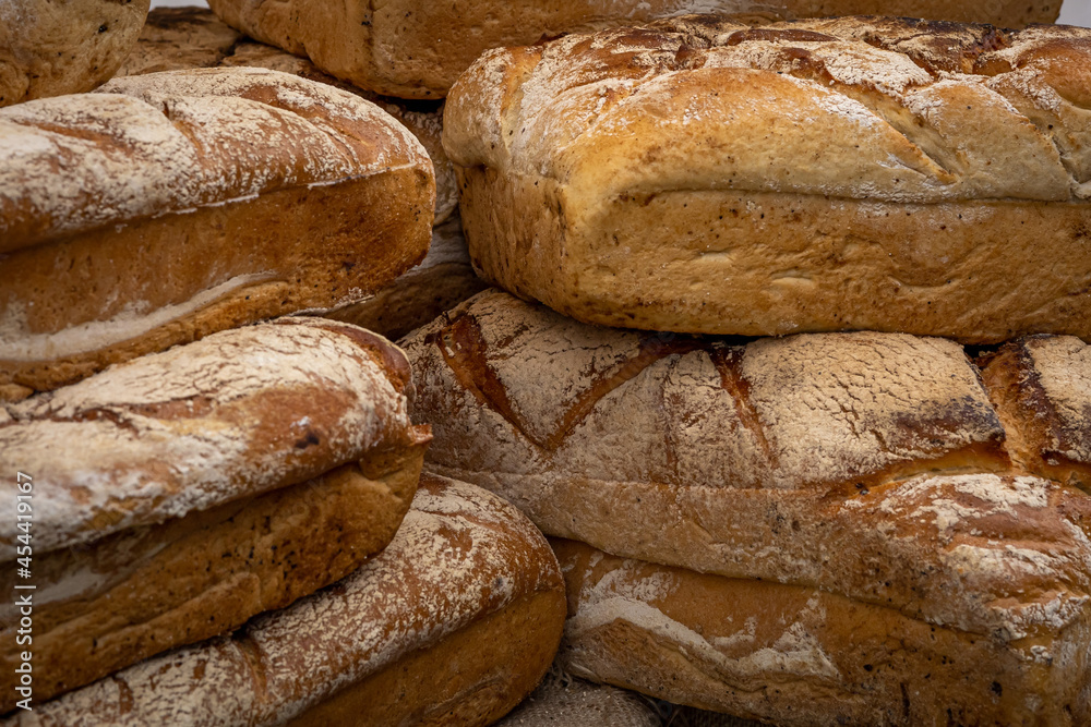 A pile of loaves of fresh artisan bread. 