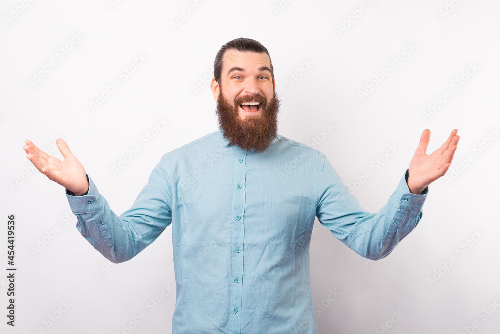 Let me give you a hug. Bearded man is standing with arms open wide ready for an embrace over white background.