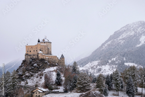 Tarasp castle in a misty and snow covered landscape