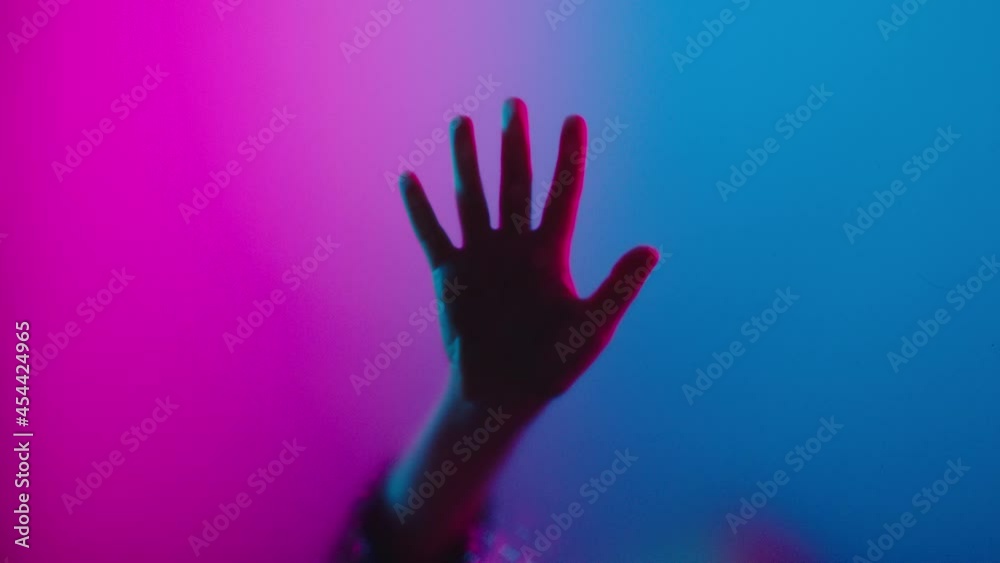 hand on window with colorful retro lights pink and blue hand on window with colorful retro lights pink and blue
