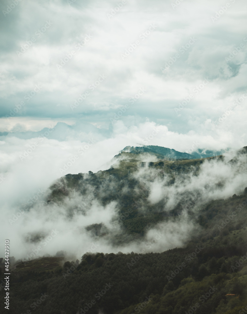 Mountain appears beneath the clouds on a cloudy day in Basque Country