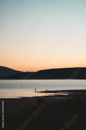 Man coming out of the water of a lake during sunset in Spain © Eneko Aldaz