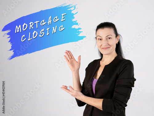 Financial concept meaning MORTGAGE CLOSING with sign on the gray wall