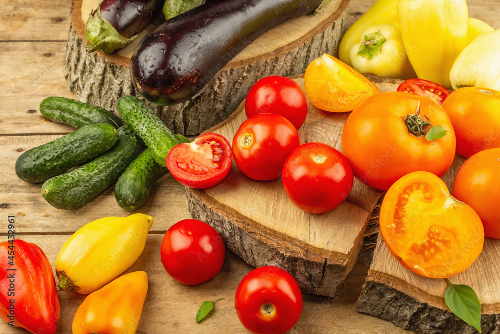 Assortment of fresh vegetables on a wooden background Assortment of fresh vegetables on a wooden background