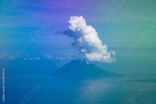Aerial view from the plane, of the clouds clinging to the top of Manadotua Island, in Bunaken National Park, Sulawesi Island, Indonesia