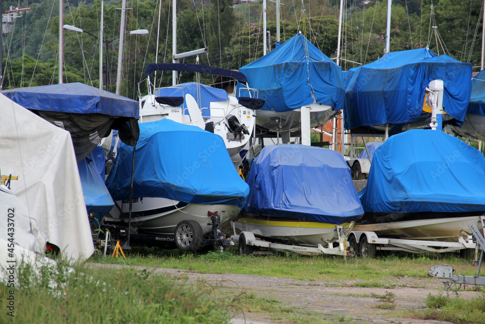 Parking and boarding of sailboats, yachts, boats covered with blue covers, stored while not being used in the lake or sea
