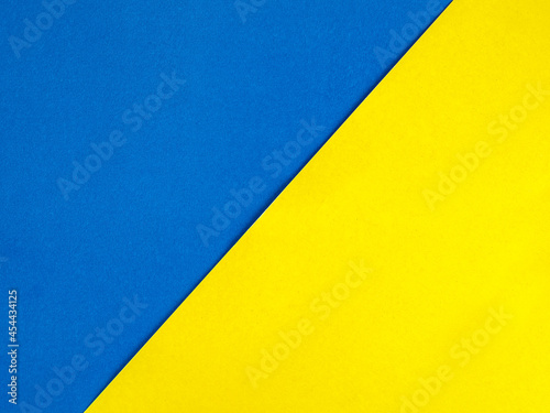 Colored paper in blue and yellow, divided in half, diagonally background