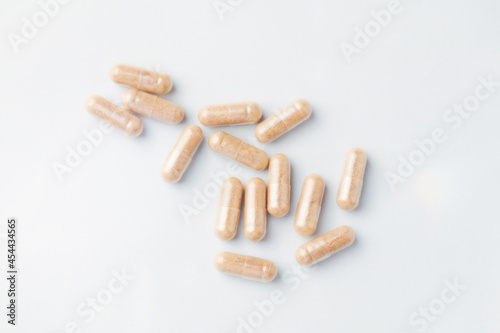 Hop Extract Capsules. Bright paper background. Top view. Close up. 