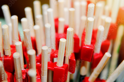 Many Chinese sticks with red plastic nozzles. Student Chinese Sticks