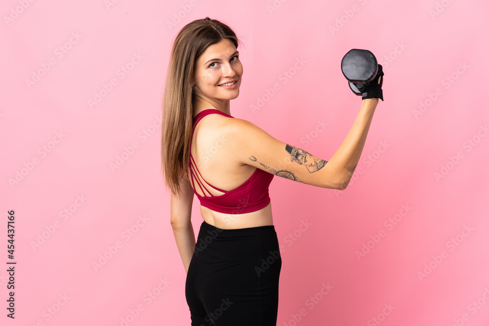 Young slovak woman isolated on pink background making weightlifting Young slovak woman isolated on pink background making weightlifting