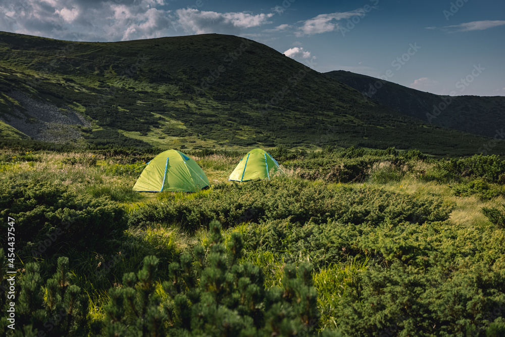 concept of vacation in the mountains. tents in the mountains. hiking in the mountains