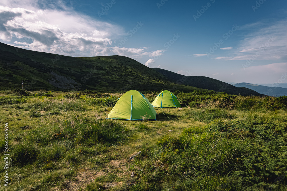 concept of vacation in the mountains. tents in the mountains. hiking in the mountains