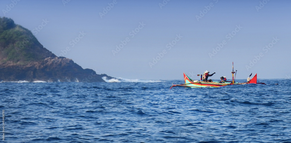 fisherman in the sea with a traditional boat