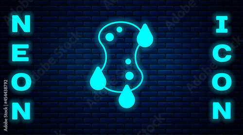 Glowing neon Sponge icon isolated on brick wall background. Wisp of bast for washing dishes. Cleaning service logo. Vector