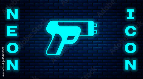Glowing neon Police electric shocker icon isolated on brick wall background. Shocker for protection. Taser is an electric weapon. Vector