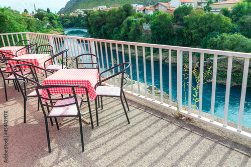Terrace with chairs and tables at Neretva riverside in Mostar   Bosnia and Herzegovina . 