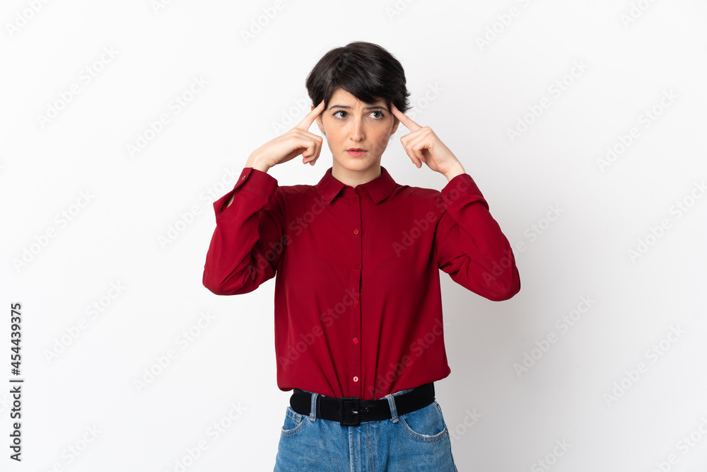 Woman with short hair isolated on white background having doubts and thinking Woman with short hair isolated on white background having doubts and thinking