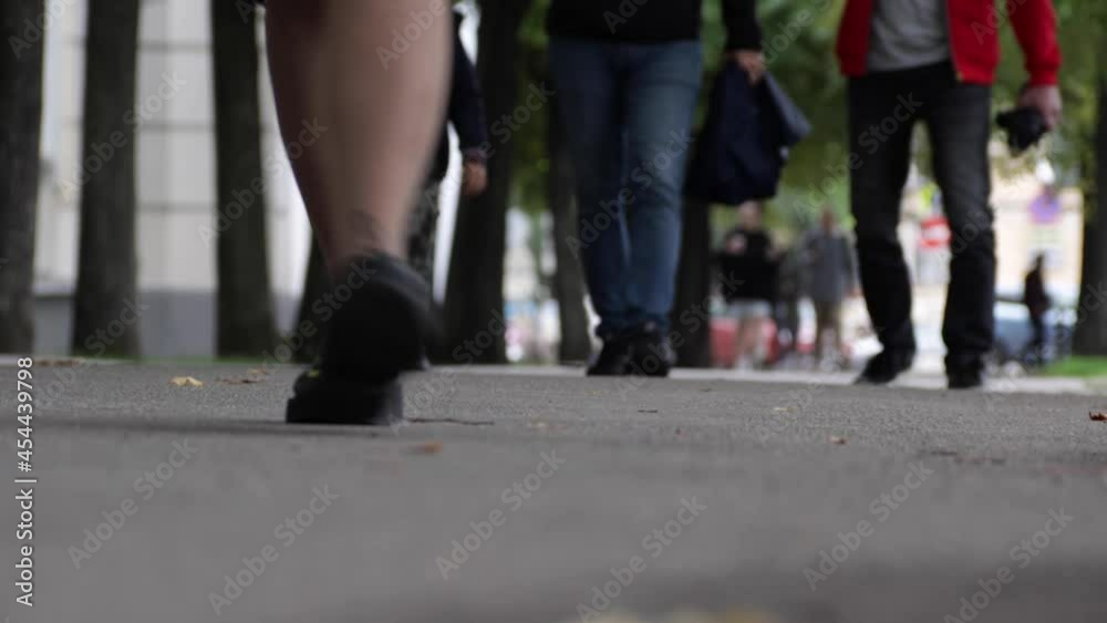 Pedestrian's legs close-up. People on the urban street Pedestrian's legs close-up. People on the urban street