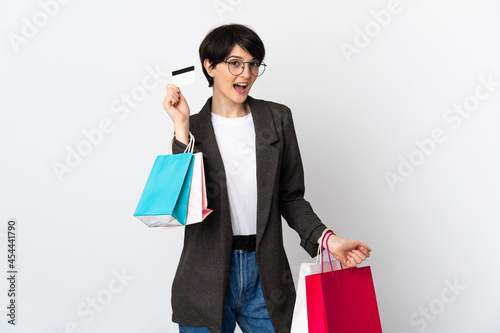 Woman with short hair isolated on white background holding shopping bags and a credit card