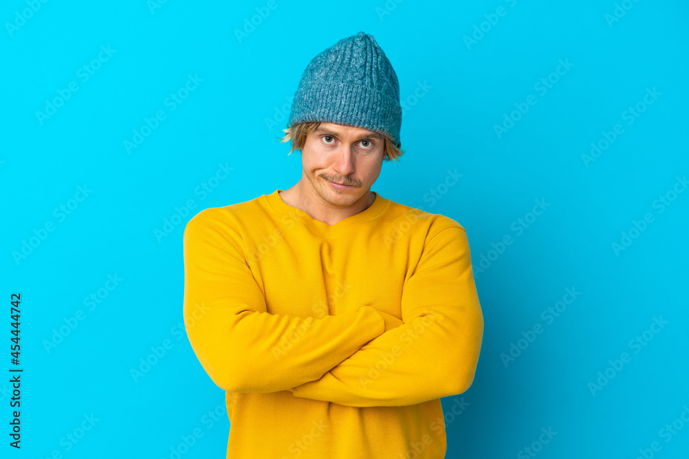Handsome blonde man isolated on blue background feeling upset Handsome blonde man isolated on blue background feeling upset