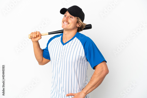 Young blonde man playing baseball isolated on white background posing with arms at hip and smiling