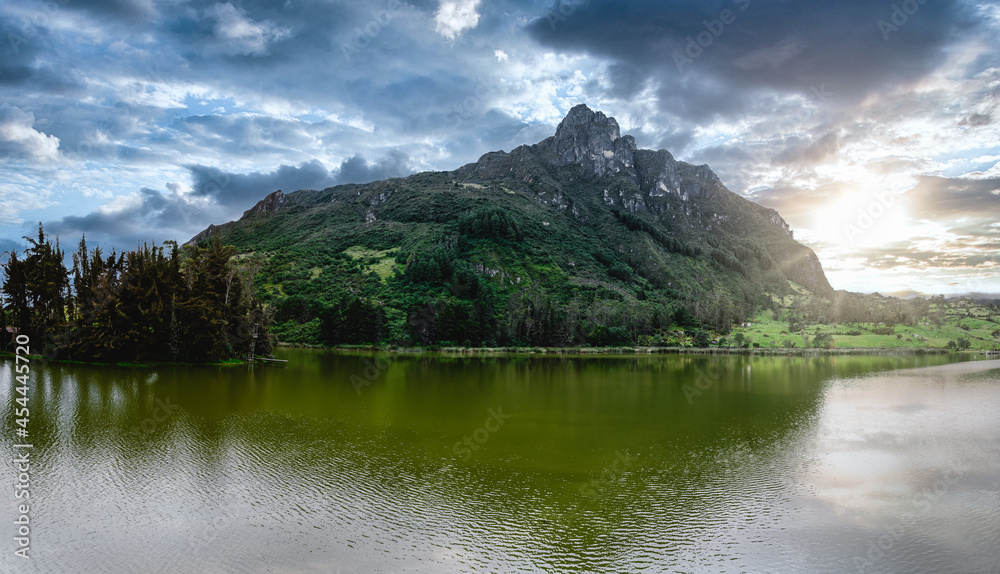 Naklejka premium Lake seen from a mountain called Pico San Pablo. It is located in Azuay, it is known as Lake Busa. The small town is observed from the mountain.