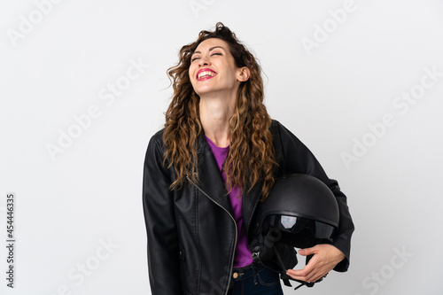 Young caucasian woman holding a motorcycle helmet laughing
