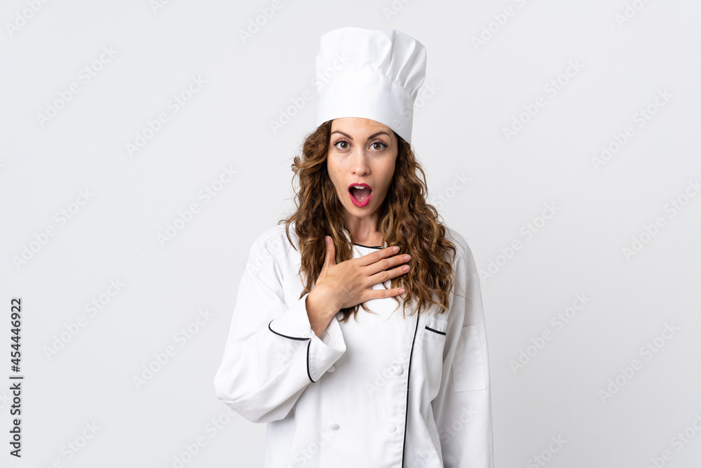 Young chef woman isolated on white background surprised and shocked while looking right Young chef woman isolated on white background surprised and shocked while looking right