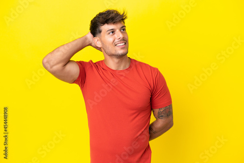 Young caucasian handsome man isolated on yellow background thinking an idea