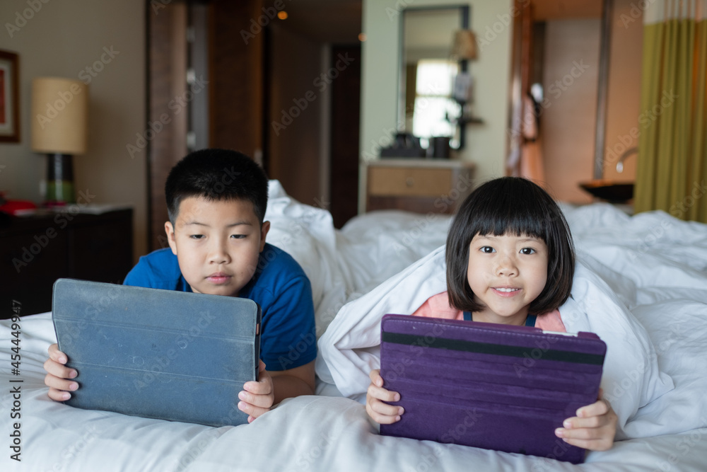 two children addicted tablet, asian kid watching cartoon two children addicted tablet, asian kid watching cartoon