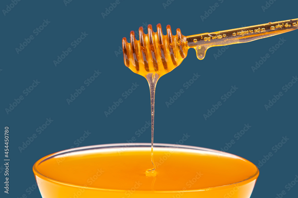 fresh honey drips from a spoon into a plate. organic vitamin health food fresh honey drips from a spoon into a plate. organic vitamin health food