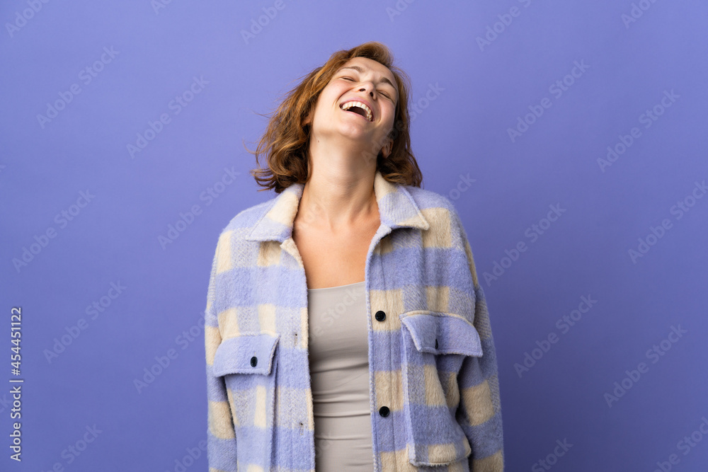 Young Georgian woman isolated on purple background laughing Young Georgian woman isolated on purple background laughing