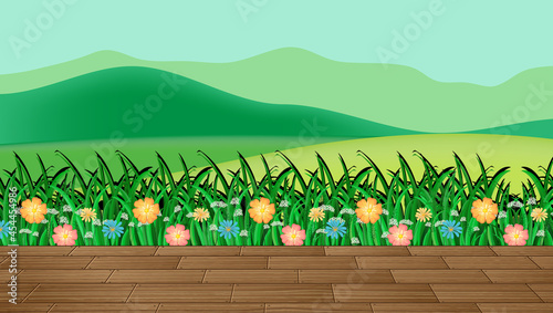 Flower field and green grass with mountain backdrop