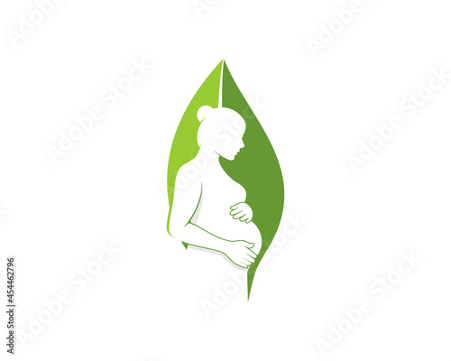 Pregnant mom in the nature green leaf