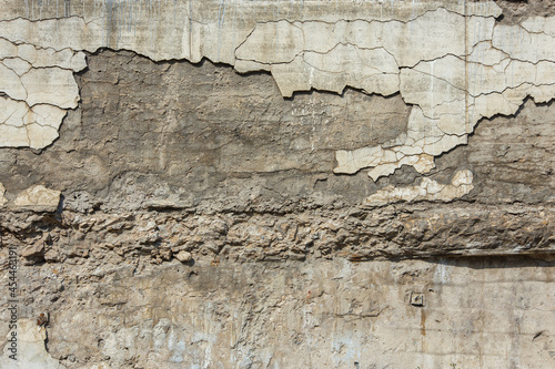 cracked white concrete wall under direct sun light full frame background and texture photo