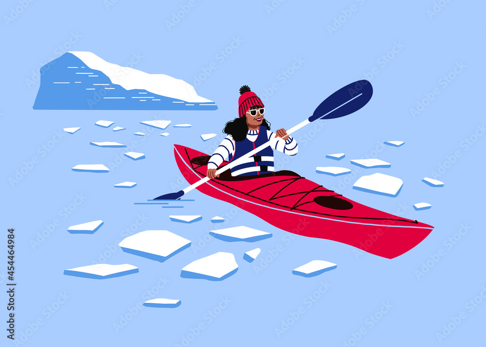 Female kayaking in icy waters. Rowing a kayak through  frozen arctic sea near an iceberg glacier. 