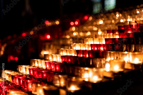 Closeup shot of candle flame rows in a shape of a stairway photo