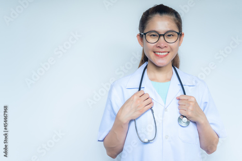 Portrait of Asian healthcare worker preapring her stethoscope before working in hospital isolated on white background. © boyloso